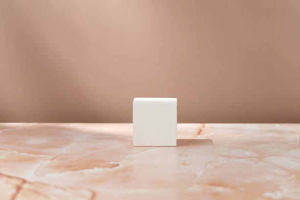 istock White squared podium, pedestal on beige pink marble background and shadows on the wall. Blank, scene. Mockup. Mock up. 1434477953