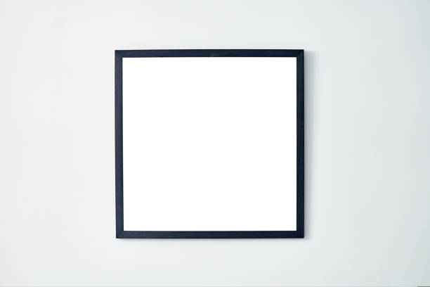 istock An empty square photo frame with a black border hanging on a white wall 1434480184