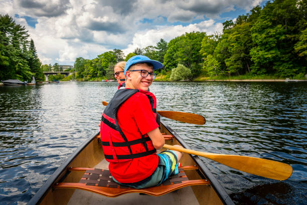 mother and her son are canoeing at Fairy Lake in Huntsville in Canada Mother and her son are canoeing at Fairy Lake in Huntsville in Canada. It is part of the Algonquin Provincial Park. huntsville ontario stock pictures, royalty-free photos & images