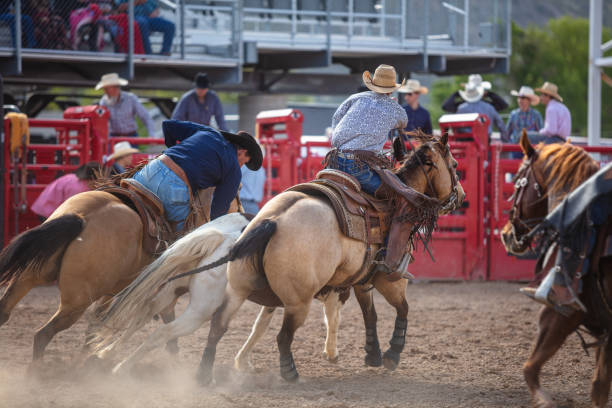 istock Horseback Riders Riding Horses In a Rodeo Inside Arena 1434481742