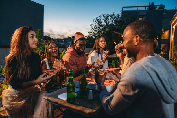 istock Dinner party with friends on a rooftop at night 1434485840