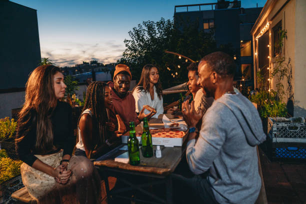istock Dinner party with friends on a rooftop at night 1434485867