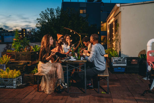 istock Dinner party with friends on a rooftop at night 1434485868