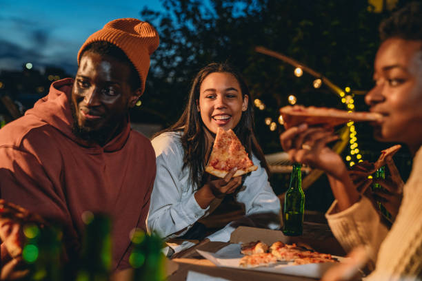 Friends are dining together with pizza stock photo