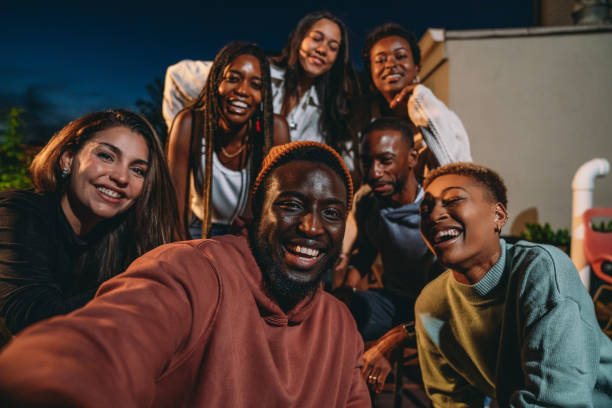 istock Multiethnic group of people are taking a selfie together during a dinner party 1434485889