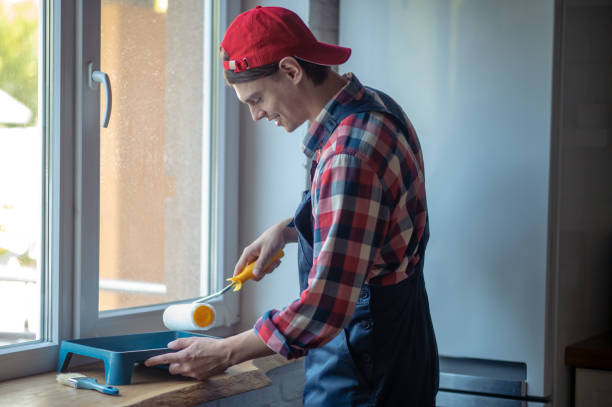 istock Joyful repairman preparing for painting the window frame 1434487517