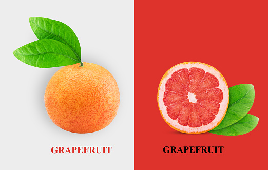Grapefruit citrus fruit one cut in half, with green leaf isolated on white and red background. Clipping Path. Full depth of field.