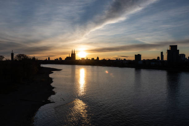 Skyline of Cologne with Cologne Cathedral and Rhine river at sunset