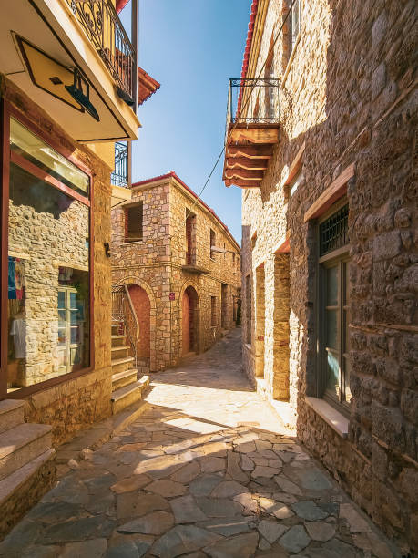 Sunlight in Narrow Street of Arachova Narrow cobbled streets of resort town of Arachova on the slopes of Mount Parnassus, Greece arachova greece stock pictures, royalty-free photos & images