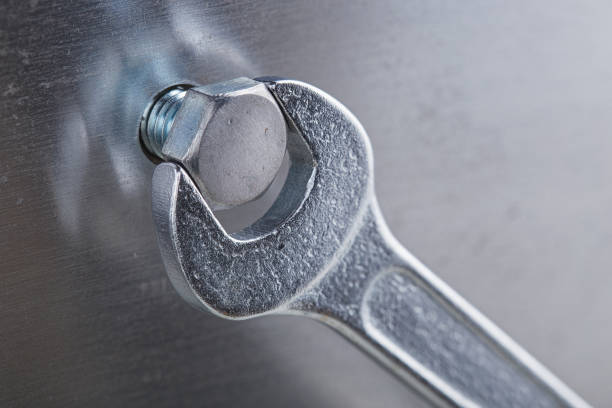 istock Wrench tightens bolt in steel billet. Spanner, bolt, screw and nuts. 1434491512