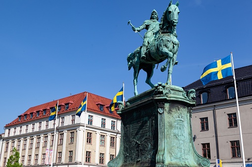 Gothenburg, Sweden – June 07, 2013: The statue of Charles IX on horseback in a square with buildings under the clear sky, Gothenburg, Sweden