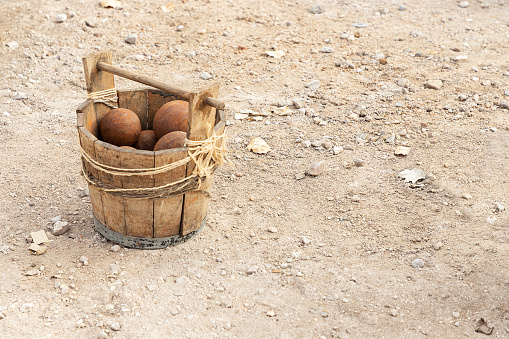 wooden basket with ancient cannon balls