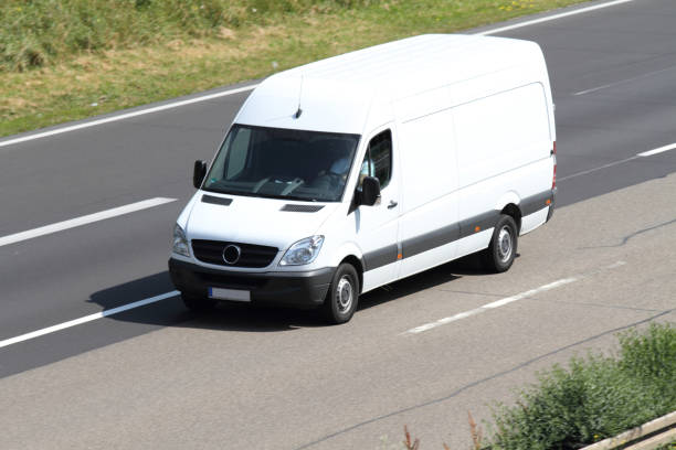 a white van on the highway a delivery truck on the highway transporter stock pictures, royalty-free photos & images