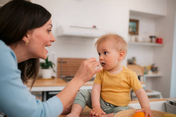 istock Mother feeding her baby boy at home 1434502434