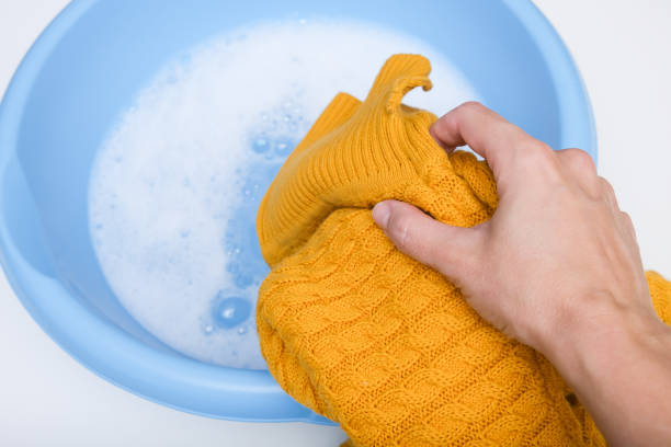 Hand washing of delicate woolen knitted clothes, sweaters concept.