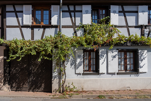 View of a white typical Alsatian facade in the village