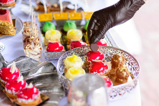 istock Hands in black gloves serves sweets. Catering 1434503274