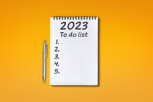 2023 To do list lettering on squared notebook, isolated on orange background