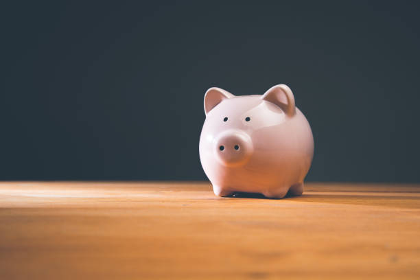 istock Piggy bank on a wooden table 1434505334