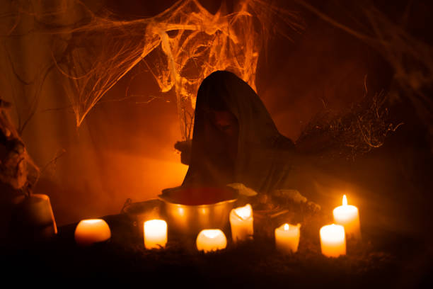 istock A young witch in hood does voodoo black magic ritual on the Witch's book. Halloween's horror. Scary story. 1434505733
