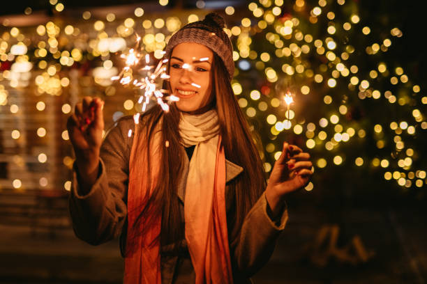 istock Young Woman Holding Sparkles Outdoors At Christmas 1434509163