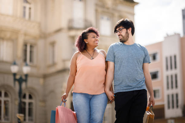 istock Happy couple wolking hands while looking at each other 1434509282