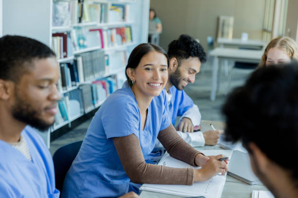 istock Female medical student smiles at unrecognizable friend 1434510089