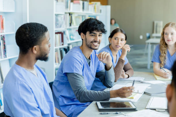 istock Medical students listen to two students' discussion 1434510121
