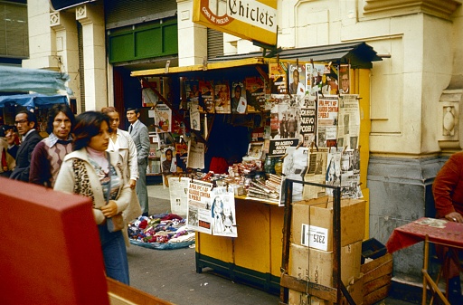 Lima, Peru, 1976. Small newspaper booth in Lima. Also: pedestrians.