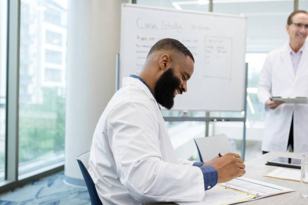 istock Doctors share lighthearted moment in tense meeting 1434511346