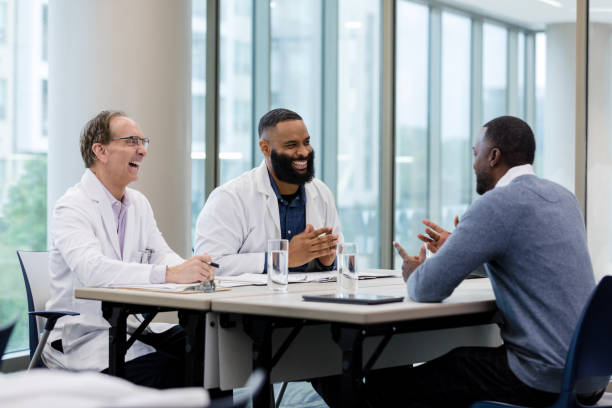 istock Doctors laugh while listening to male pharmaceutical sales representative 1434511353