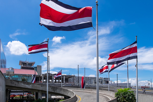 Alajuela, Costa Rica - September 22, 2022: Entrance gates with country flags outside the Juan Santamaría International Airport