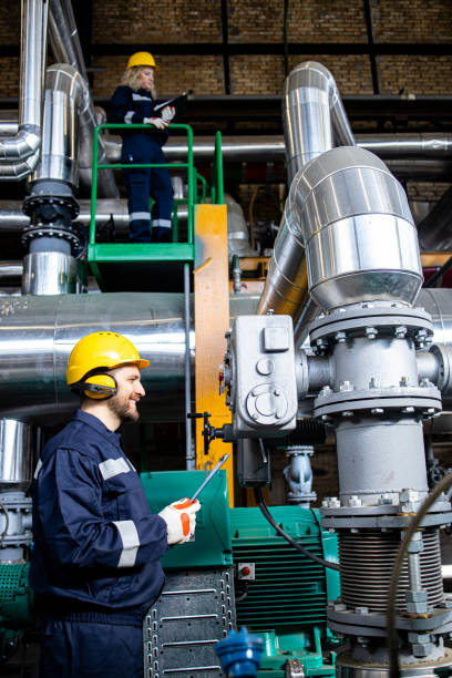 istock Professional power plant worker checking generator engines and pipeline installations. 1434513474