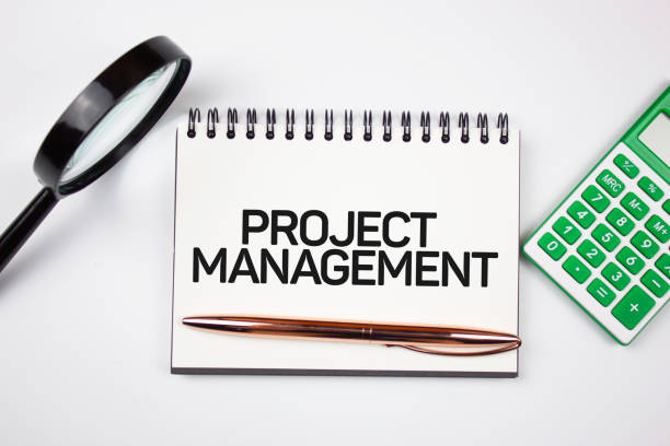 istock PROJECT MANAGEMENT text on notepad next to calculator. Calculation of cost in financial services. 1434513746
