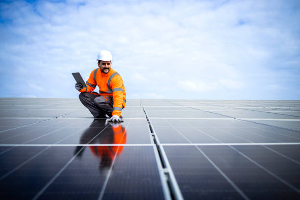 istock Engineer inspector holding digital tablet and working in solar panels power plant checking photovoltaic cells and electricity production. 1434514293