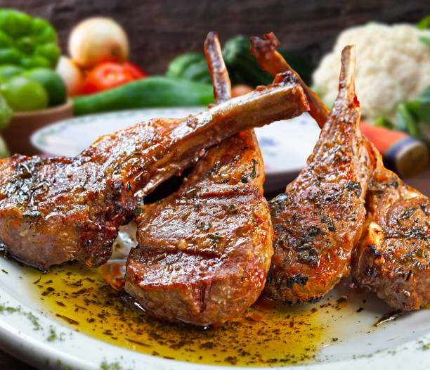 Roasted lamb chop Roasted lamb chops with olive oil and herbs plate rack stock pictures, royalty-free photos & images