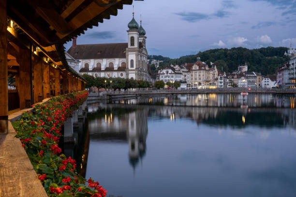 Vibrant Sunrise Over Jesuit Church St Francis Cavier in Lucerne, Switzerland's Downton District and the Reuss River Sunrise over the beautiful downtown district of Lucerne, which is known for its medieval architecture, and the beautiful Reuss River. lucerne switzerland stock pictures, royalty-free photos & images