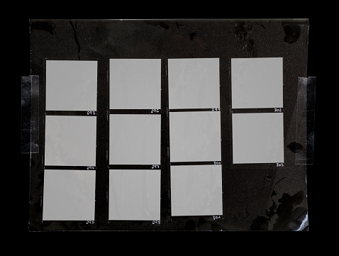 macro photo of black and white handcopy contactsheet with many empty film frames.