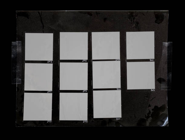 macro photo of black and white handcopy contactsheet with many empty film frames. handcopy contactsheet with blank film frames fixed by transparent sticker tape on dark background. contact sheet photos stock pictures, royalty-free photos & images