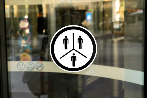 Sign on Revolving glass door, background with copy space, full frame horizontal composition