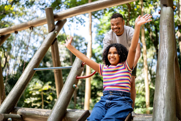 istock Father and daughter playing at a park 1434523046