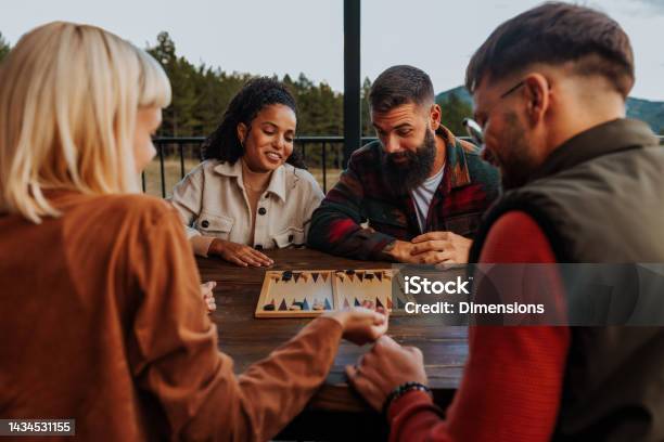 Friends Playing Backgammon On Mountain Stock Photo - Download Image Now - Board Game, Playing, Playful