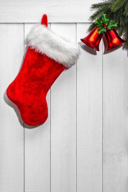 istock An empty Christmas stocking and bells hung on white wooden wall 1434531709