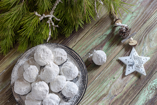 Traditional, greek New Year or Christmas cookies with almonds (kourabies) on a wooden table close-up.