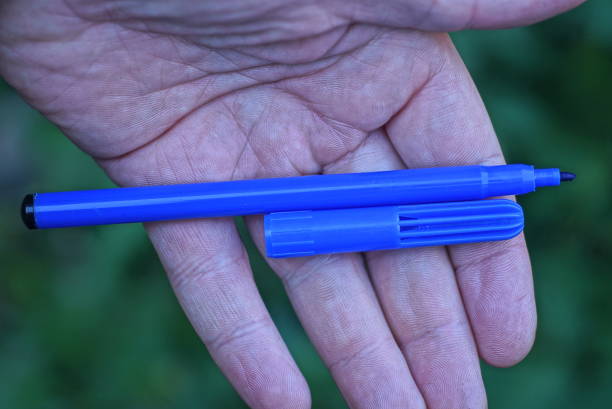 istock one open plastic felt-tip pen with a cap lies on an open palm 1434536570