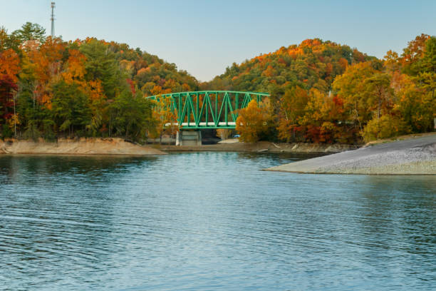 istock Green truss bridge behind blue lake and boat ramp 1434537675