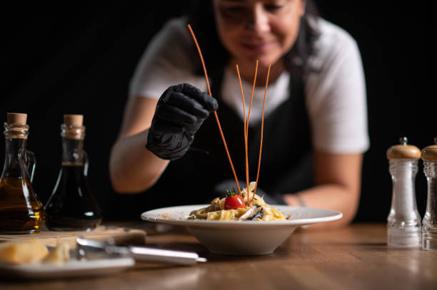 istock A female chef decorating a plate in a restaurant 1434540899