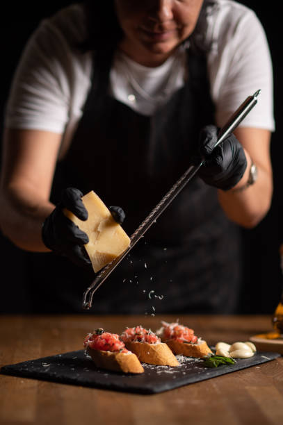 istock A female chef grating cheese on bruschetta 1434542609