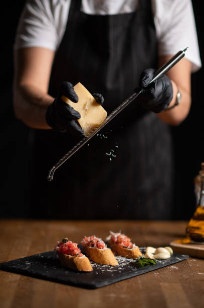 istock A female chef grating cheese on bruschetta 1434542637