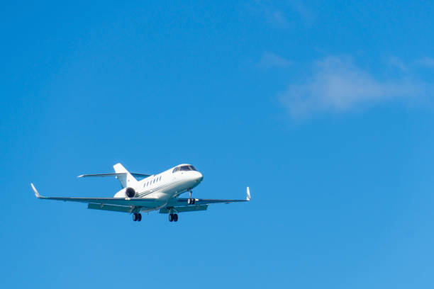 Small corporate jet taking off at airport.